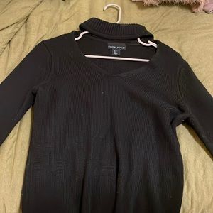 Black sweater. High neck. Chest cut out. Belled sleeves.